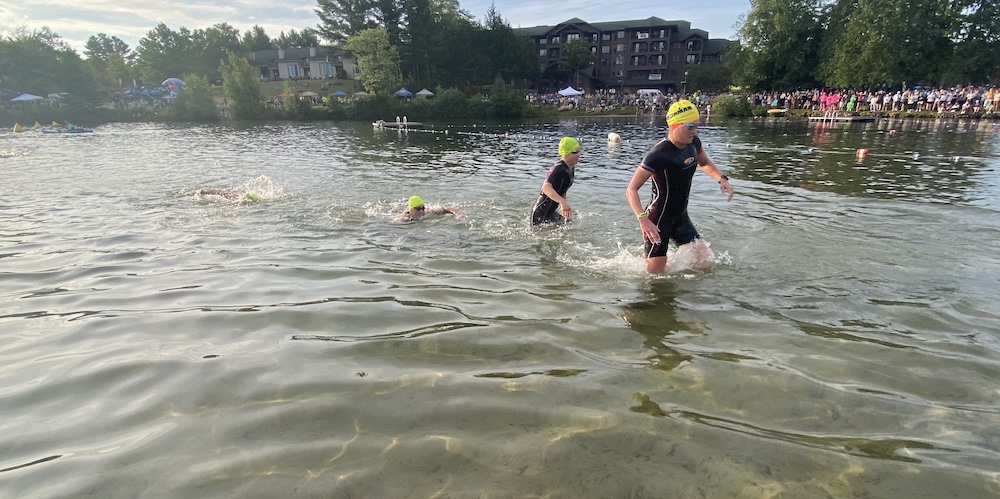 pro women exiting water wearing swim skins at ironman lake placid